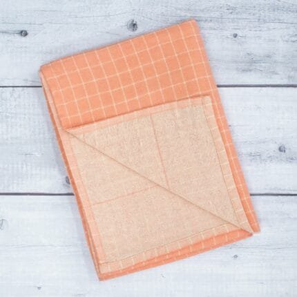 Zero twist dual layer 100 percent pure cotton bath towel neatly folded on a soft lifestyle background, showcasing plush texture and thickness