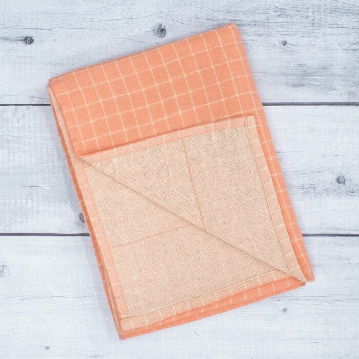 Zero twist dual layer 100 percent pure cotton bath towel neatly folded on a soft lifestyle background, showcasing plush texture and thickness