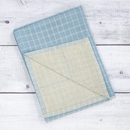 Zero twist dual layer 100 percent pure cotton bath towel neatly folded on a soft lifestyle background, showcasing plush texture and thickness