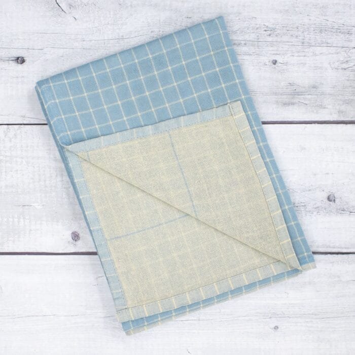 Zero twist dual layer 100 percent pure cotton bath towel neatly folded on a soft lifestyle background, showcasing plush texture and thickness
